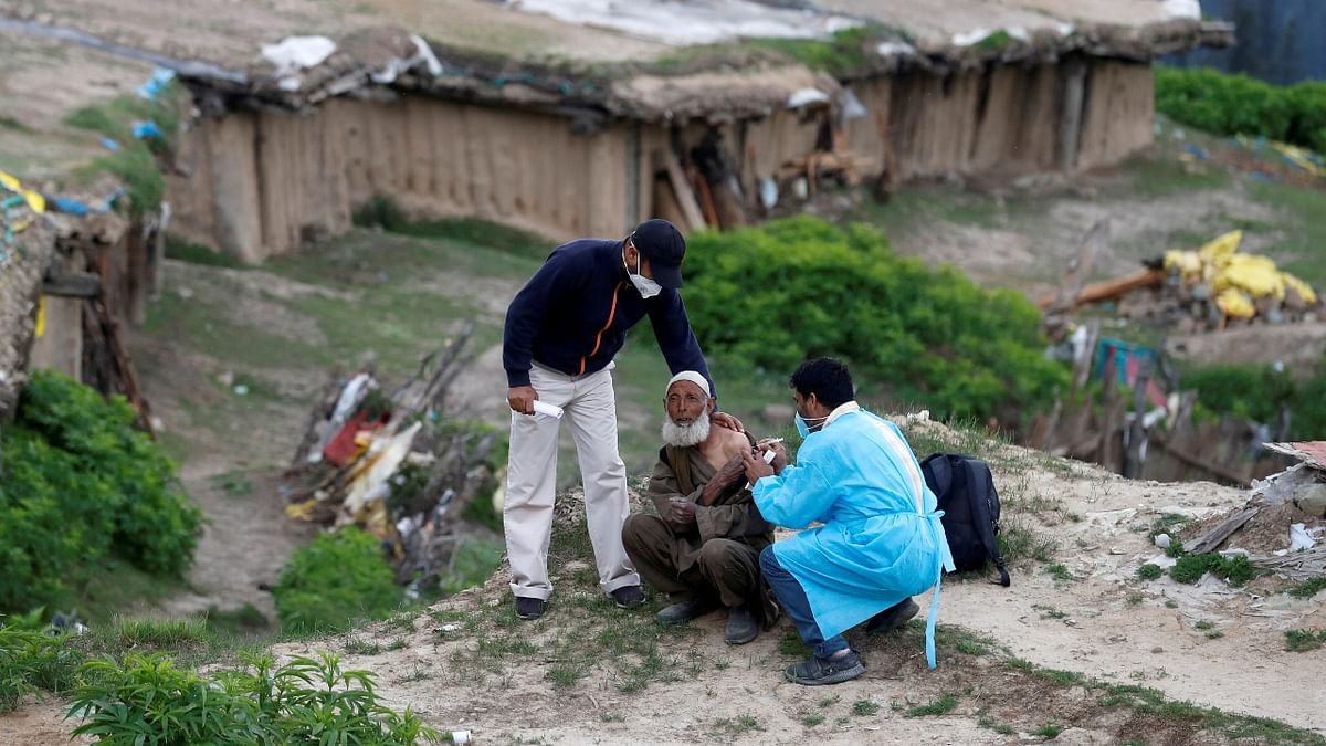 A shepherd is seen receiving a dose of Covishield during a vaccination drive at Tosa Maidan in Budgam district, Kashmir. Credit: Reuters Photo