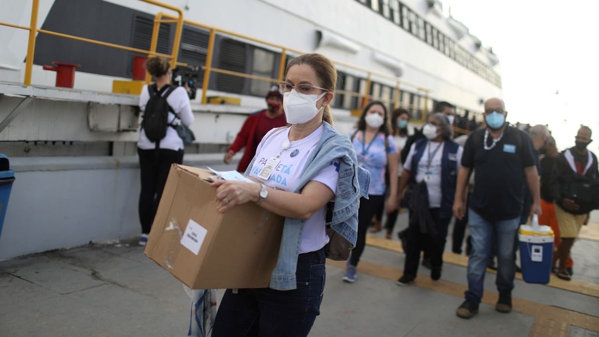 Health workers carrying AstraZeneca vaccines arrive for the mass vaccination at Paqueta Island, Guanabara Bay, in Rio de Janeiro, Brazil. Credit: Reuters Photo