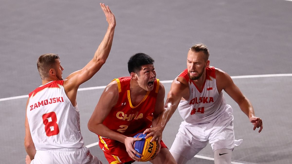 Hu Jinqiu of China in cation with Przemyslaw Zamojski of Poland and Szymon Rduch of Poland during a match. Credit: Reuters Photo