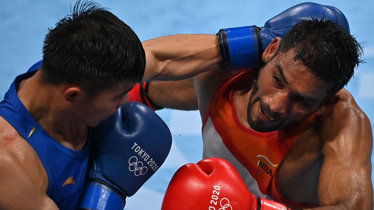 Tuoheta Erbieke and Ashish Kumar in action during a preliminaries boxing match. Credit: Reuters Photo