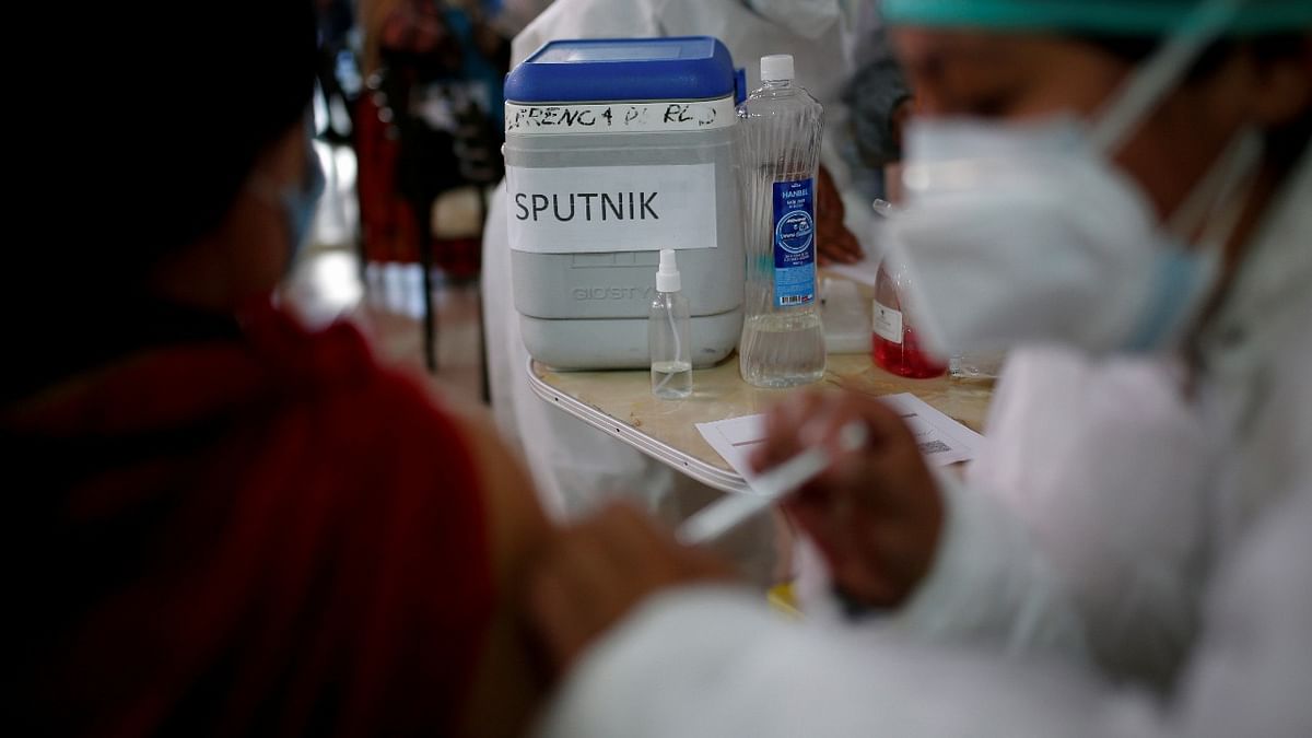 A person receives Russia's Sputnik V vaccine against Covid-19 at a Mi Teleferico cable car station turned into a vaccination centre, in El Alto, Bolivia. Credit: Reuters photo