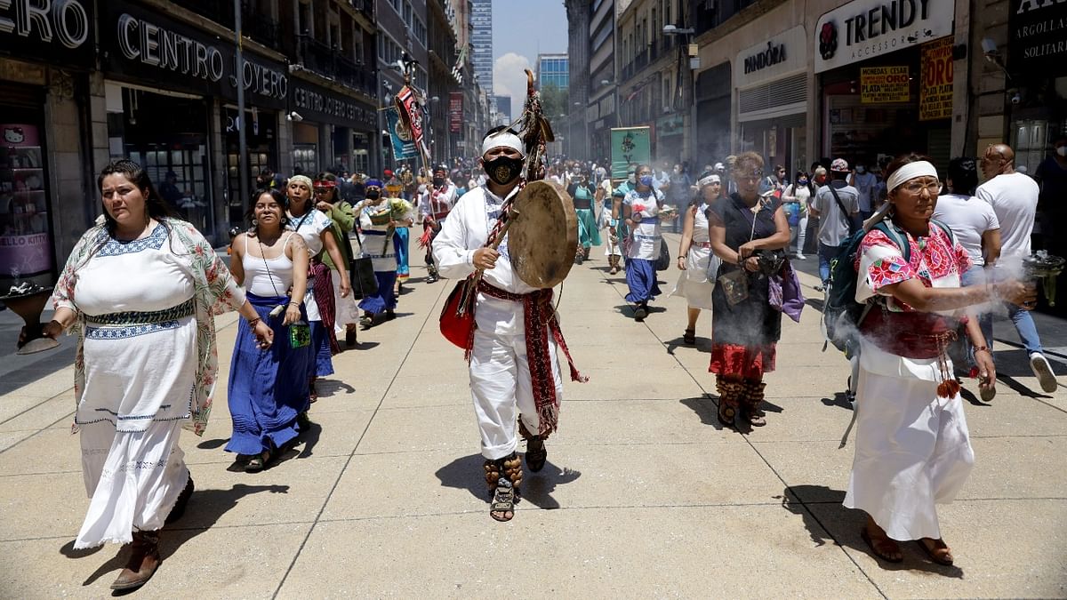 Dancers march toward Zocalo square to mark the 696th anniversary of the founding of Mexico-Tenochtitlan, in Mexico City. Credit: Reuters photo