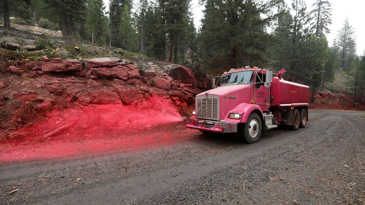 Jason Stover, 42, a private contractor from Grass Valley sprays retardant along the