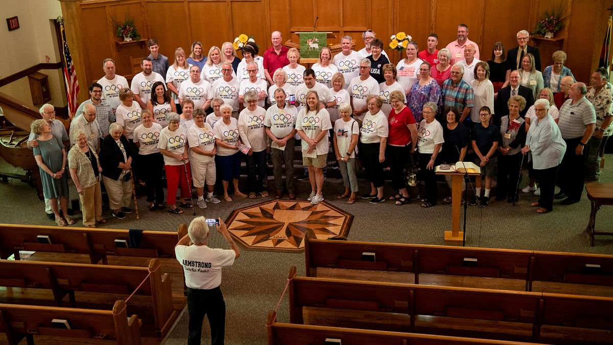 Members of the Dover First Moravian Church cheer for US swimmer Hunter Armstrong. Credit: Reuters Photo