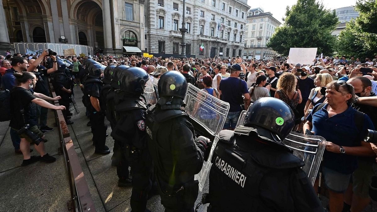 Police officers block protesters outside Milan's City Hall. Credit: AFP Photo