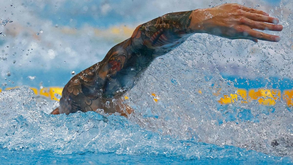 USA's Caeleb Dressel's tattoos are photographed during a semi-final of the men's 100m freestyle swimming event. Credit: AFP Photo