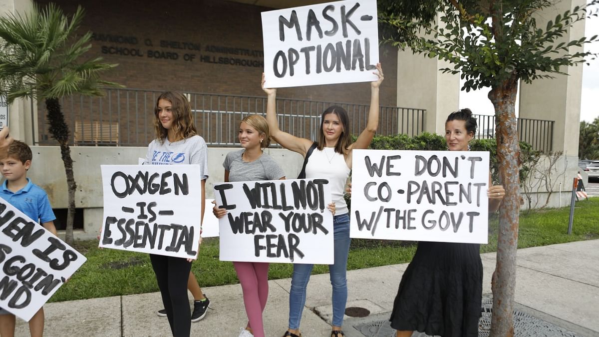 Families protest any potential mask mandates before the Hillsborough County Schools Board meeting held at the district office on July 27, 2021 in Tampa, Florida. Credit: AFP Photo