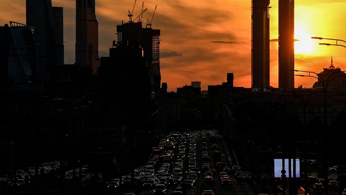Traffic jam is pictured with the Moscow's International Business Centre (Moskva City) skyline in the background in Moscow on July 27, 2021 at sunset. Credit: AFP Photo