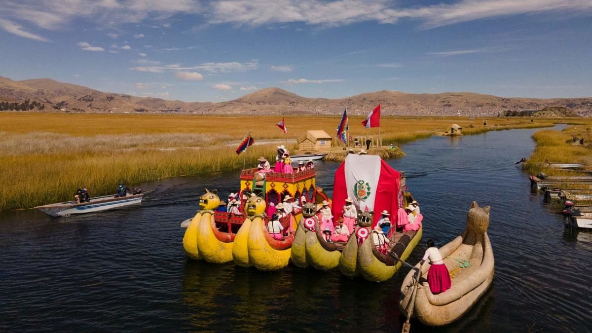 Artisians of the Qota Tika association march on boats with the Peruvian flag during a celebration in commemoration of Peru's bicentennial of the Indenpendence Day, near Lake Titicaca in Puno, Peru. Credit: AFP Photo