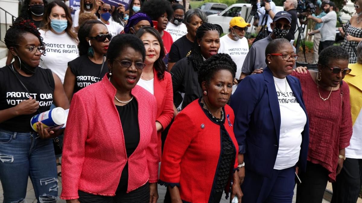 Voting rights activists, led by (L-R) Co-chair of National African American Clergy Network Barbara William Skinner, US Rep. Sheila Jackson Lee (D-TX), President and CEO of the National Coalition on Black Civic Participation Melanie Campbell and Cora Masters Barry, wife of the late D.C. Mayor Marion Barry, participate in a protest on Capitol Hill. Credit: AFP Photo