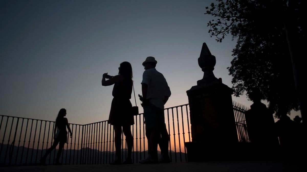 Tourists visit Ronda at sunset on July 29, 2021. - The prospects for Spain's tourism sector are getting bleaker, with European reservations slowing over soaring Covid cases, but industry figures hope the summer won't resemble the catastrophe of 2020. Credit: AFP Photo