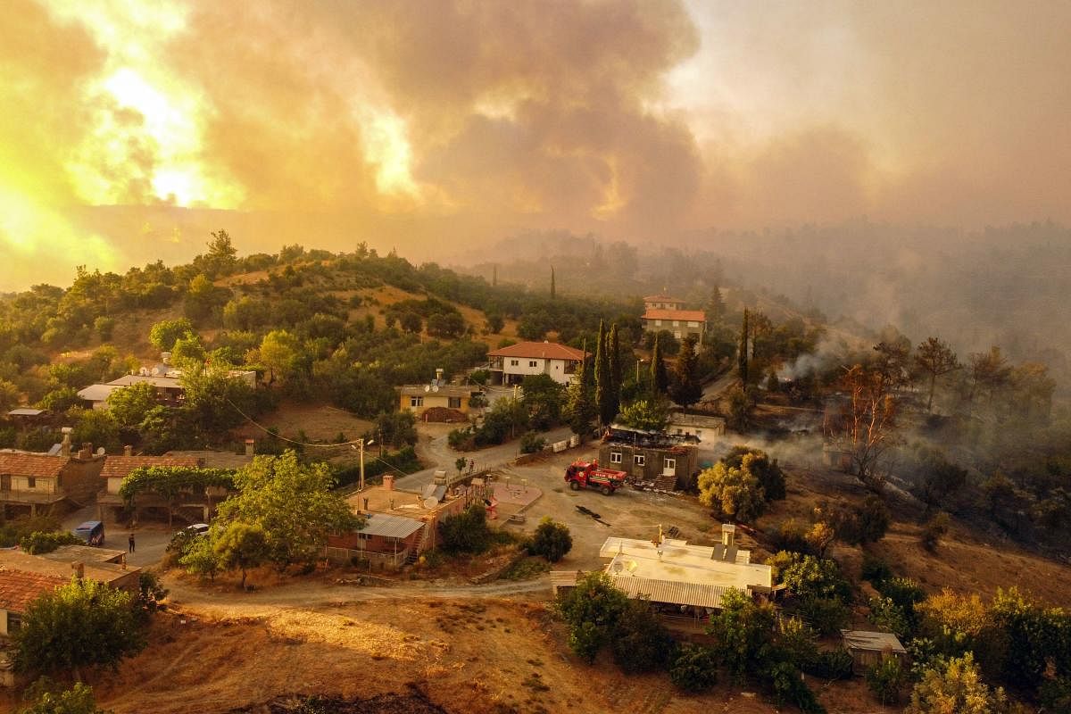 This aerial photograph shows houses surrounded by a wildfire which engulfed a Mediterranean resort region on Turkey's southern coast near the town of Manavgat. Credit: AFP Photo