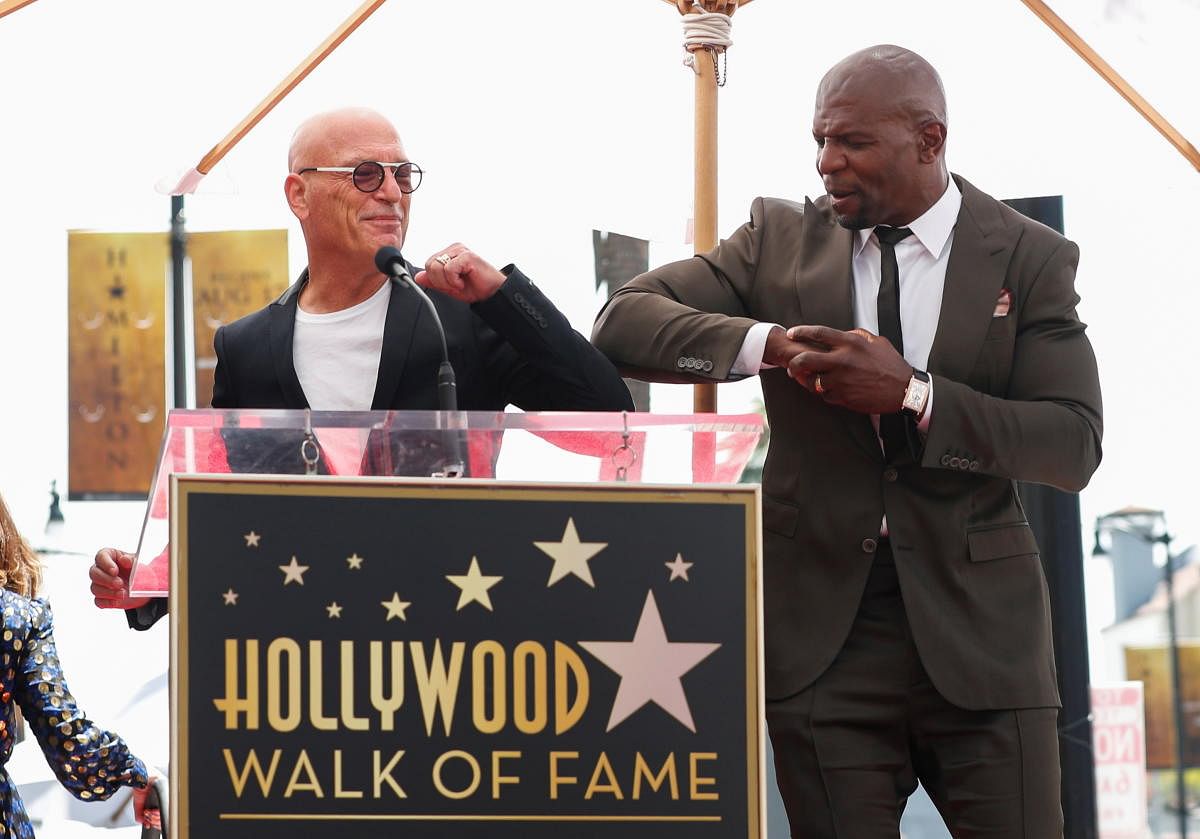 Comedian Howie Mandel greets actor Terry Crews before the unveiling of his star on the Hollywood Walk of Fame in Los Angeles, California. Credit: Reuters Photo