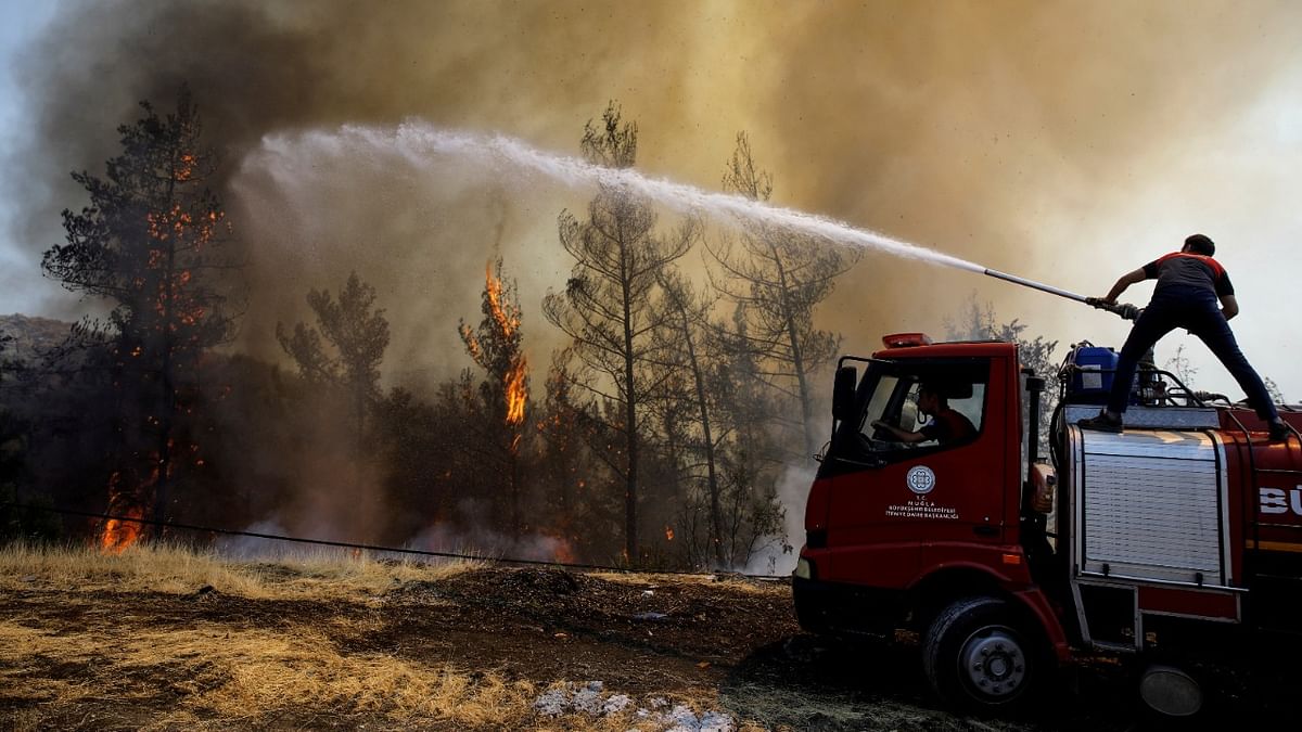 A firefighter tries to extinguish a wildfire near Marmaris, Turkey. Credit: Reuters Photo