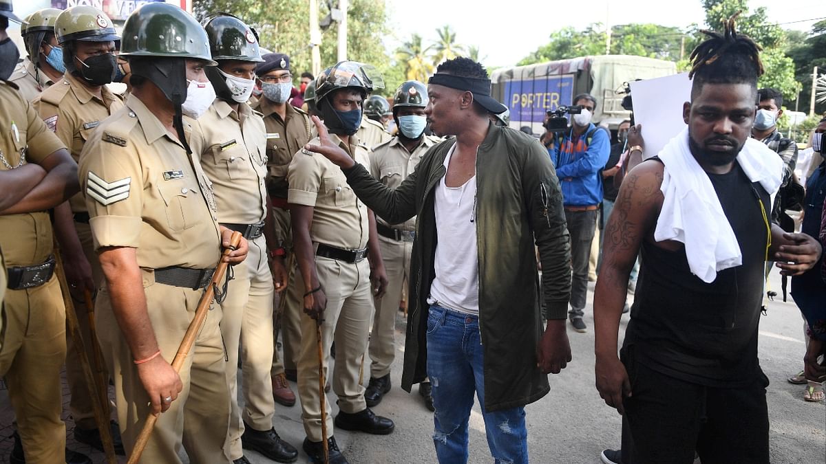 A protestor is seen interacting with the police officers in Bengaluru. Credit: PTI Photo