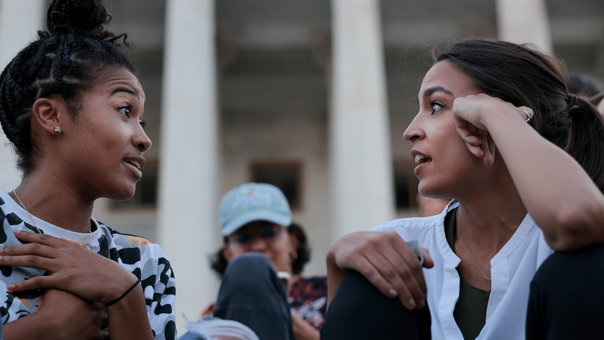 Representative Alexandria Ocasio-Cortez (D-NY), talks with Kamala Lyles, 20, during a demonstration outside the US Capitol to protest the expiration of the federal moratorium on residential evictions, in Washington, US. Credit: Reuters Photo