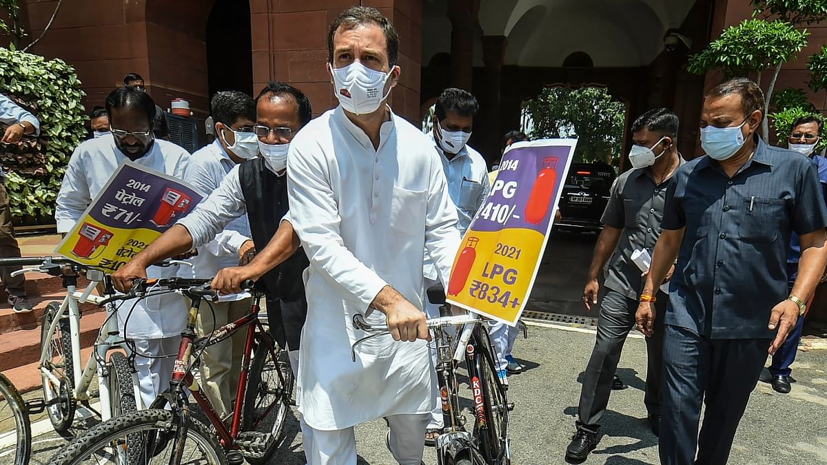 Rahul Gandhi with a bicycle in a symbolic protest over fuel price hike. Credit: PTI Photo