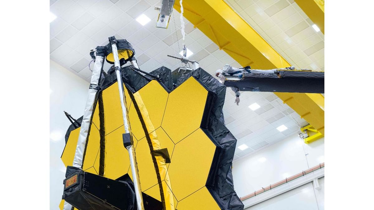 Webb's primary mirror is made of 18 hexagonal segments coated with an ultra-thin layer of gold to improve its reflection of infrared light. The telescope will be shipped to French Guiana from the company's spaceport in Redondo Beach, California. NASA targeting October 31 for liftoff on an Ariane 5 rocket. Credit: AFP Photo