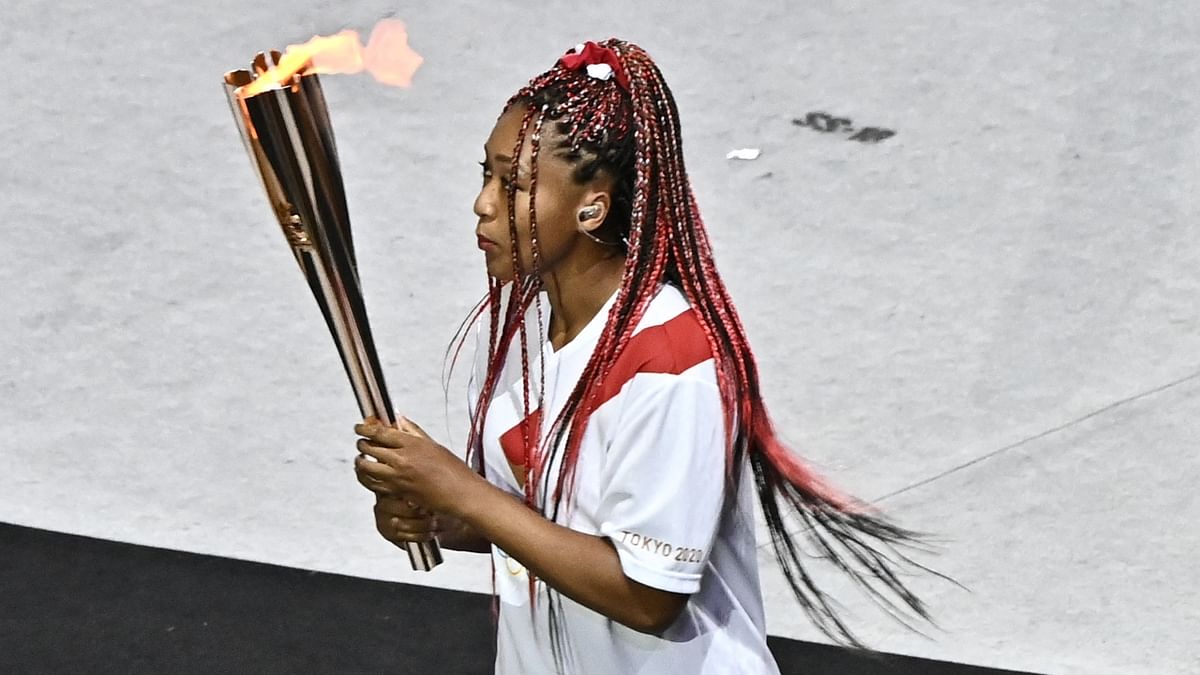 Japanese tennis star Naomi Osaka debuted bright red box braids as she lit the cauldron at the opening ceremony. Credit: AFP Photo