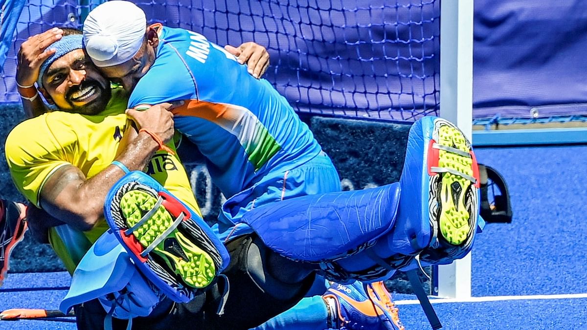 In this photo, Sreejesh Parattu Raveendran and Mandeep Singh are seen sharing a warm hug post win. Credit: Reuters Photo