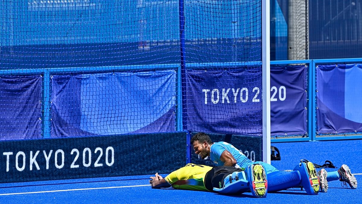 Sreejesh lies on the ground as he celebrates the team's victory over Germany. Credit: PTI Photo