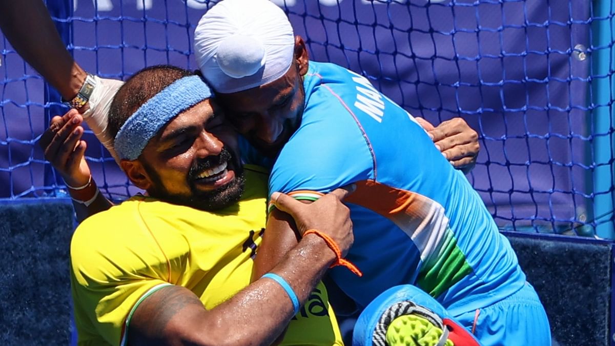 Sreejesh gets an emotional hug from Mandeep as they celebrate their team's victory over Germany. Credit: PTI Photo