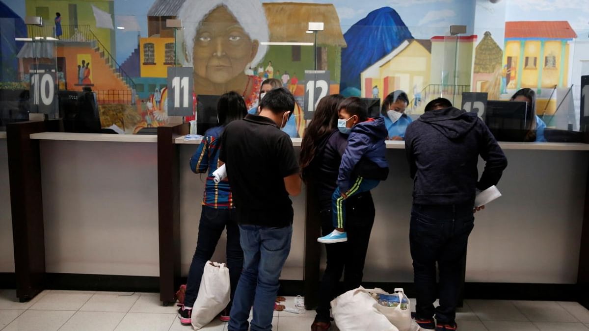 Families register at a migration facility after being deported from the U.S. under Title 42 as part of the efforts of the U.S. government to expedite removals of some families to dissuade record numbers of migrants from making the journey north, at the La Aurora International airport in Guatemala City. Credit: Reuters Photo