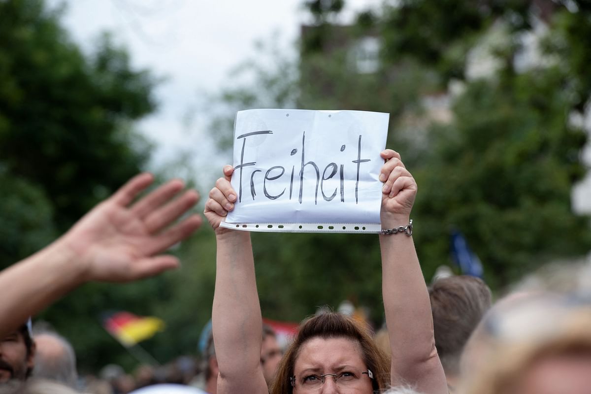 A participant holds up a placard reading 'Freedom' during a protest of supporters of the anti-lockdown 'Querdenker' movement (Lateral Thinkers) in Berlin. Credit: AFP Photo