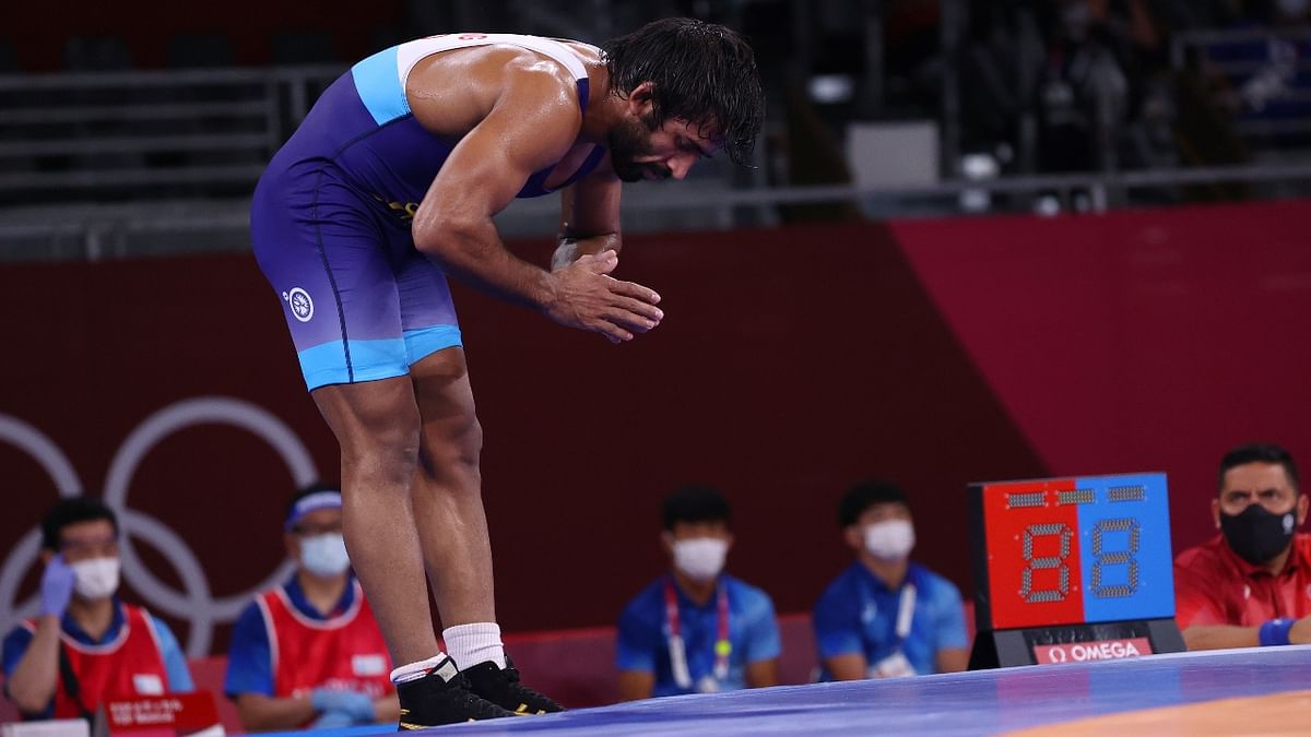 Wrestler Bajrang Punia bows down and greets the audience after winning bronze medal. Credit: Reuters Photo