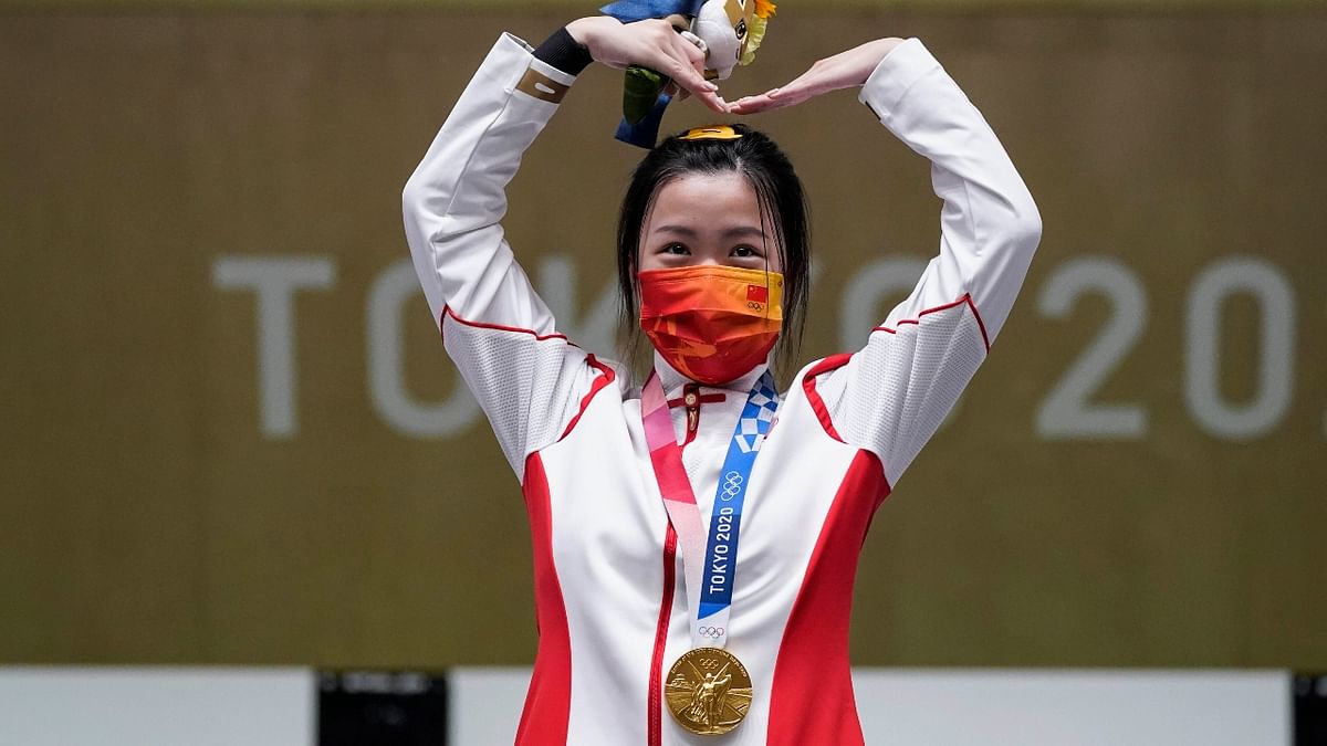 China's Qian Yang reacts after winning the gold medal in the women's 10-meter air rifle at the Asaka Shooting Range in the 2020 Summer Olympics in Tokyo, Japan. Credit: AP Photo