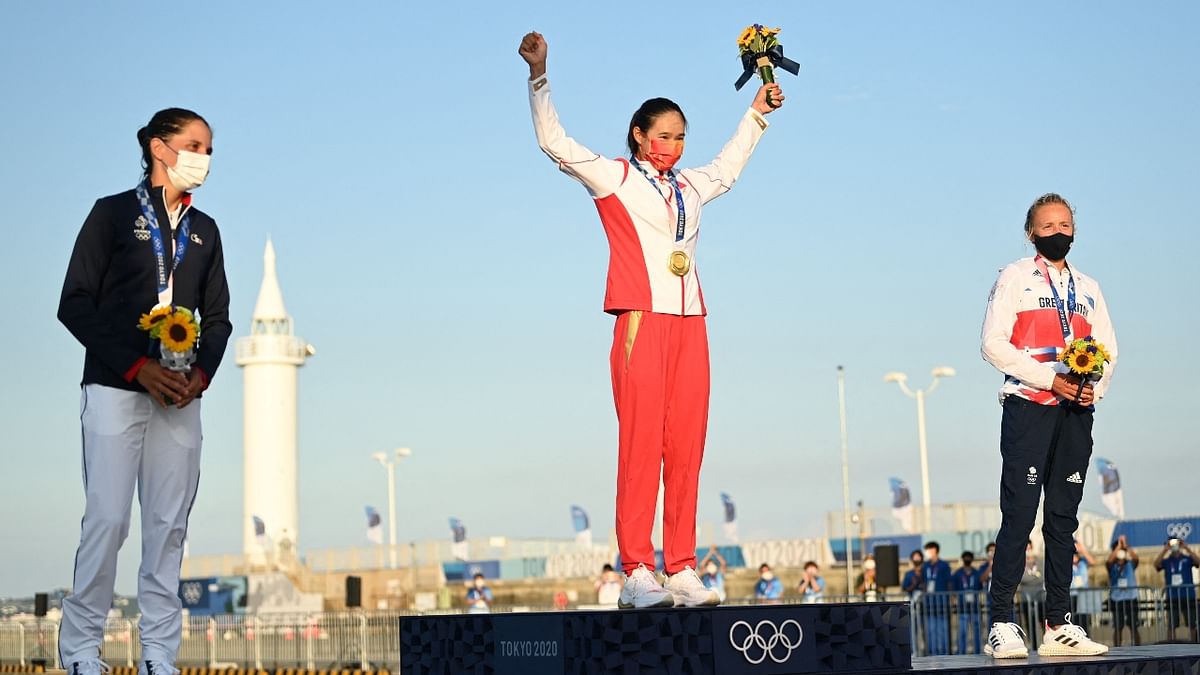 China’s Yunxiu Lu celebrates with her gold medal on the podium after the women's windsurfer RS:X medal race during the Tokyo 2020 Olympic Games sailing competition. Credit: AFP Photo
