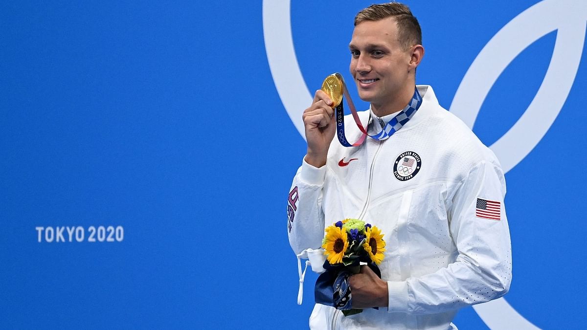 USA's Caeleb Dressel poses with the gold medal after the final of the men's 100m butterfly swimming event. Credit: AFP Photo