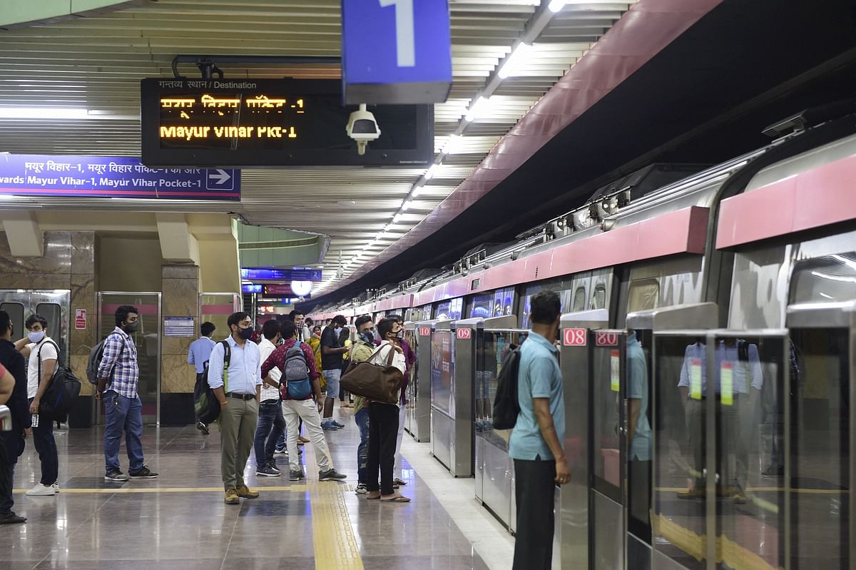 Commuters wait to board a metro train after Delhi Metro's remaining portion of the Pink Line corridor was inaugurated, in New Delhi. Credit: PTI Photo