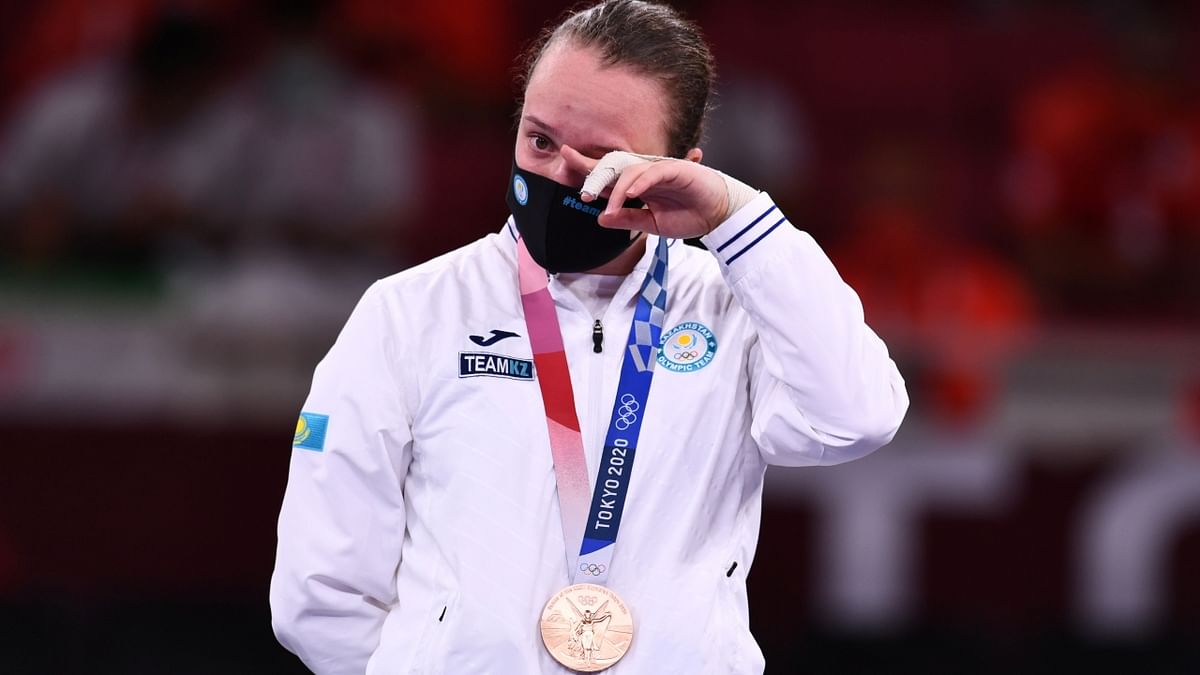 Kazakhstan's Sofya Berultseva gets emotional on the podium. She won bronze medal at Women's 61kg Kumite at Tokyo Olympics. Credit: Reuters Photo