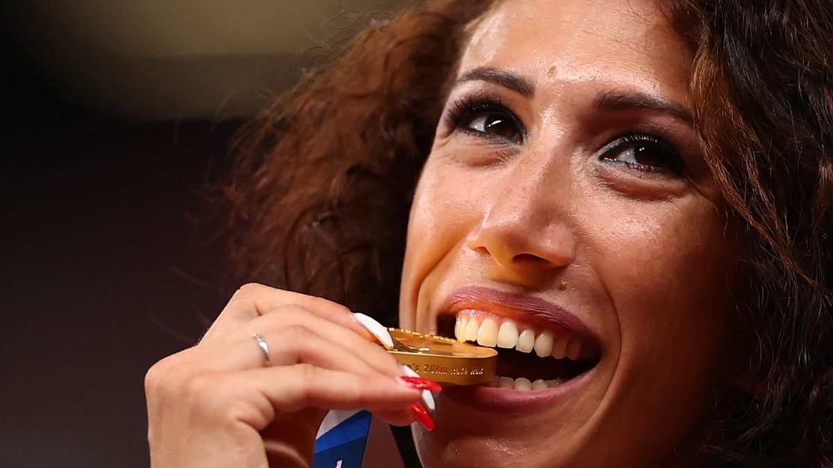 The joyous Antonella Palmisano celebrates her gold on the podium. Credit: Reuters Photo