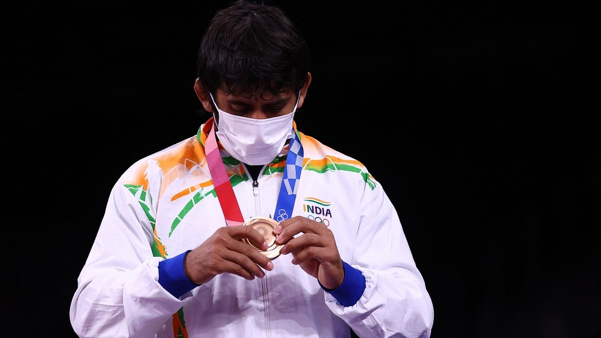 Wrestler Bajrang Punia admires his bronze medal at the Tokyo Olympics. Credit: Reuters Photo