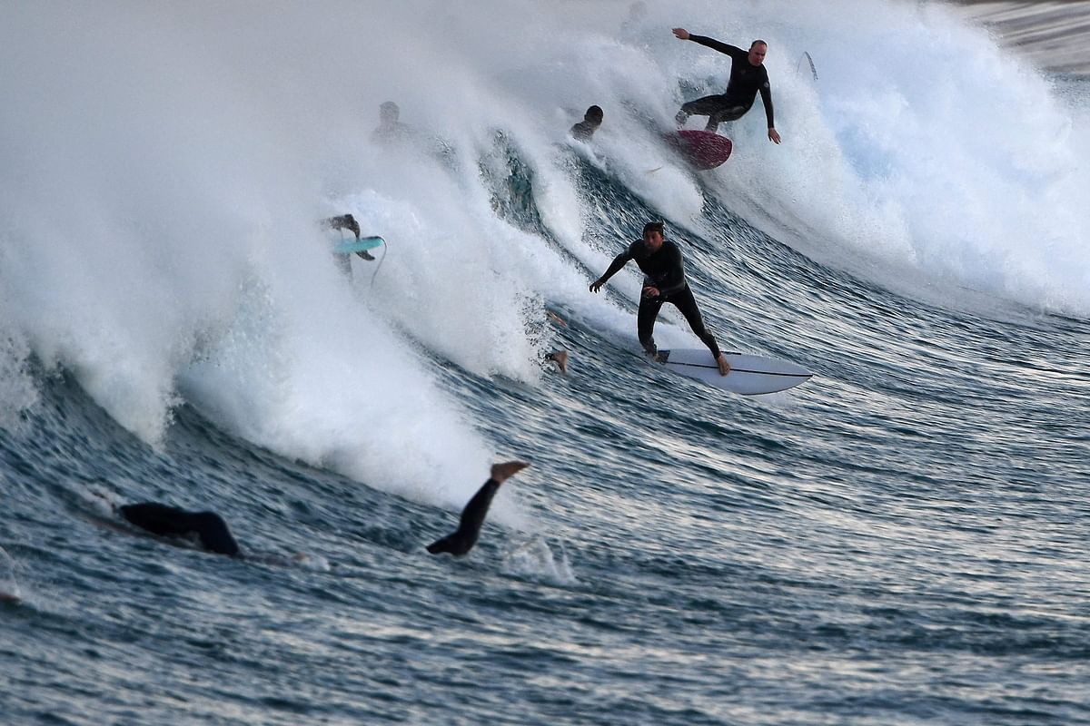 Surfers ride on the waves at the Maroubra Beach in Sydney. Credit: AFP Photo