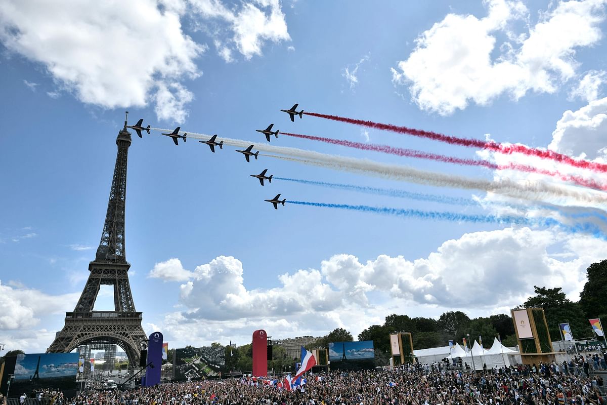 French aerial patrol 'Patrouille de France' fly over the fan village of The Trocadero set in front of The Eiffel Tower, in Paris. Credit: AFP Photo