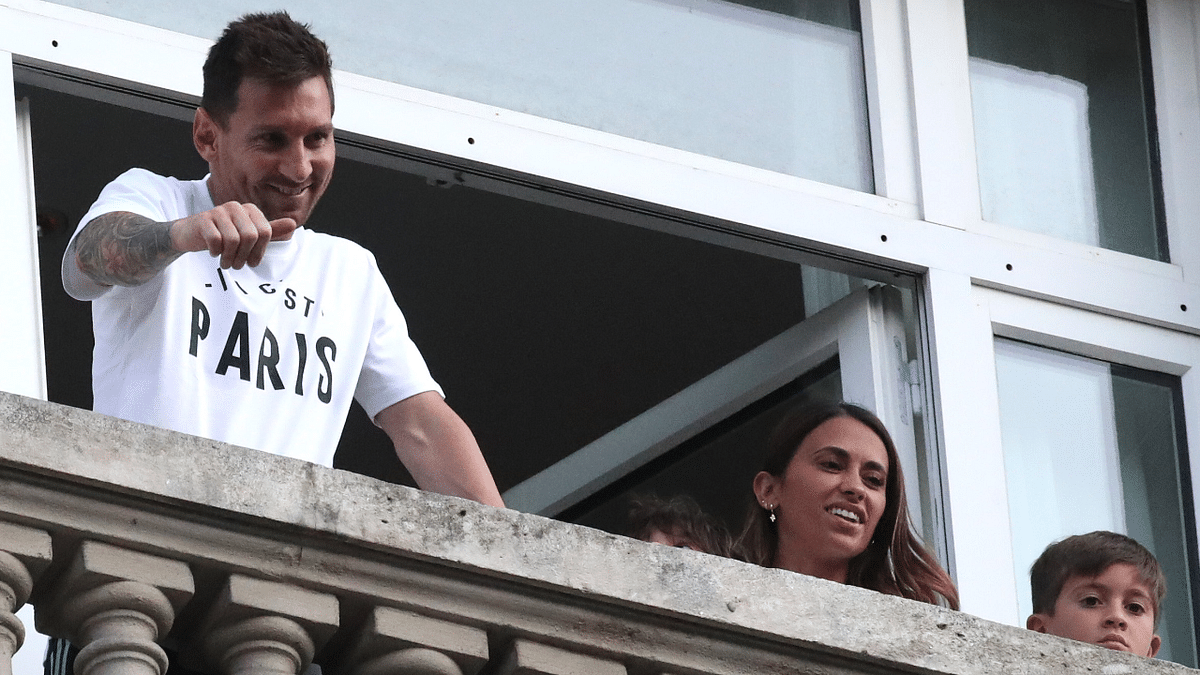 Lionel Messi arrives in Paris to join Paris St Germain. He is seen with his wife Antonela and their children from the balcony of the Royal Monceau Hotel. Credit: Reuters Photo