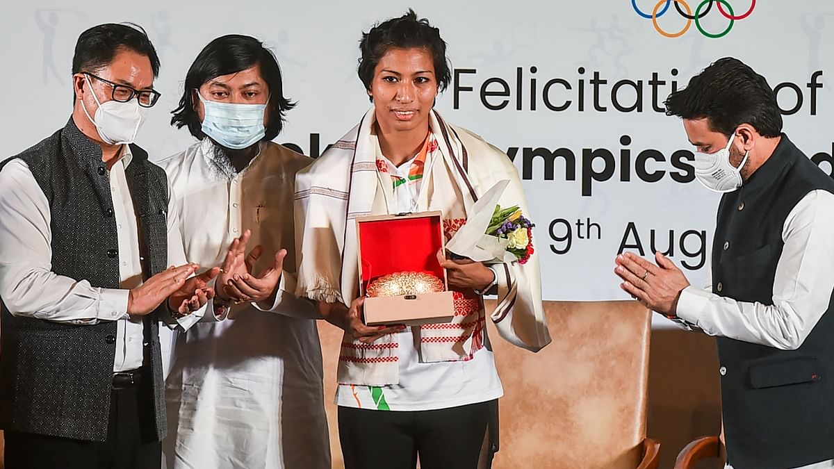 Union Ministers Anurag Thakur and Kiren Rijiju with Bronze medalist in Tokyo Olympics, boxer Lovlina Borgohain. Credit: PTI Photo
