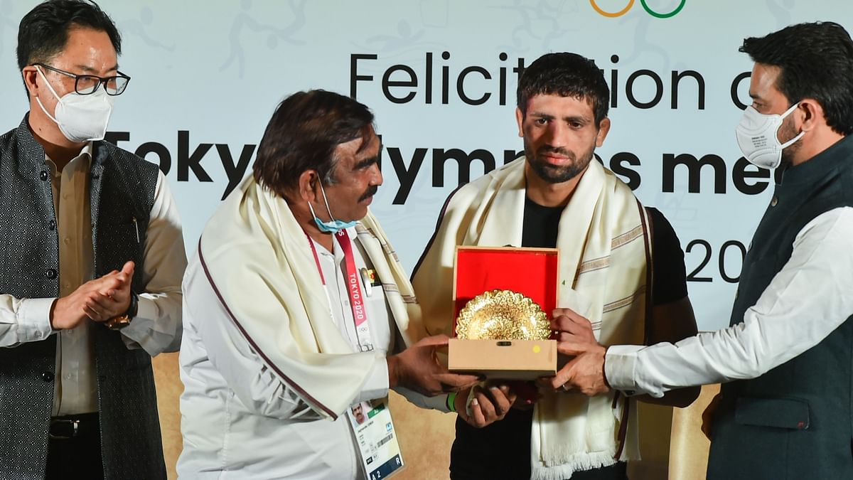 Union Minister for Youth Affairs & Sports Anurag Thakur felicitates Silver medalist in Tokyo Olympics, wrestler Ravi Dahiya. Credit: PTI Photo