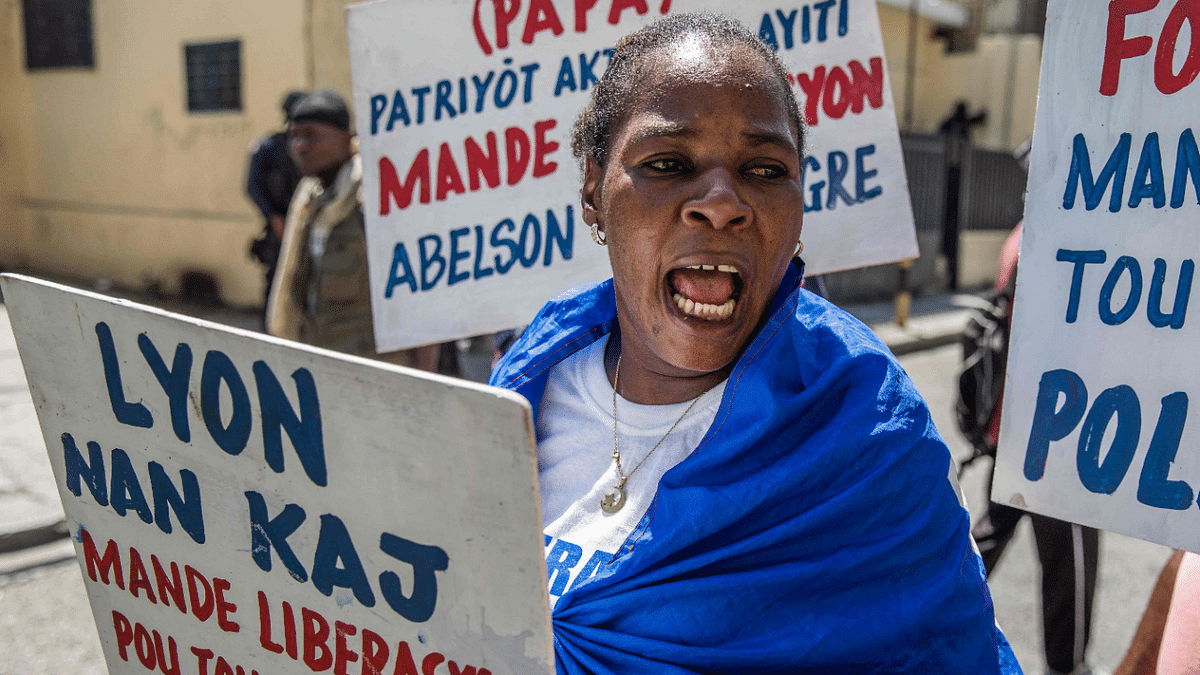 Haitians demonstrate in Port-au-Prince on August 10, 2021, during a protest organized by human rights lawyers in front of the Ministry of Justice to demand the release of political prisoners and the scheduling of criminal trials. Credit: AFP Photo