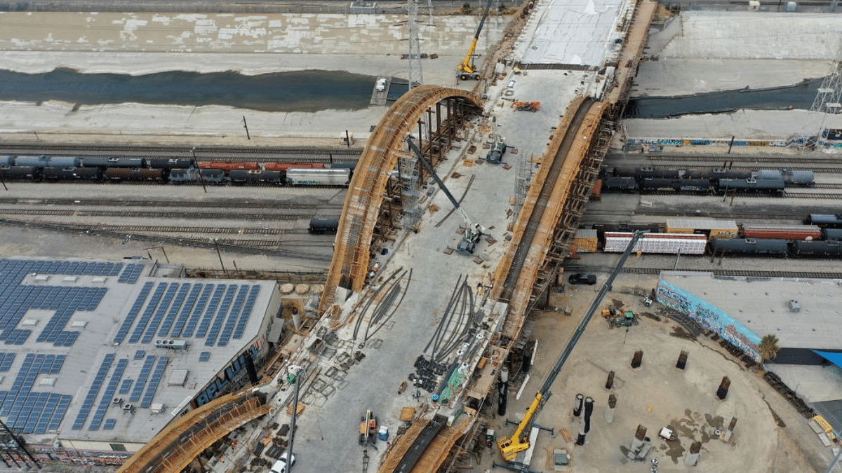 An aerial view of the construction of the Sixth Street Viaduct replacement project, adjacent to a rooftop covered in solar panels and a rail yard, in Los Angeles, California. Credit: Reuters Photo