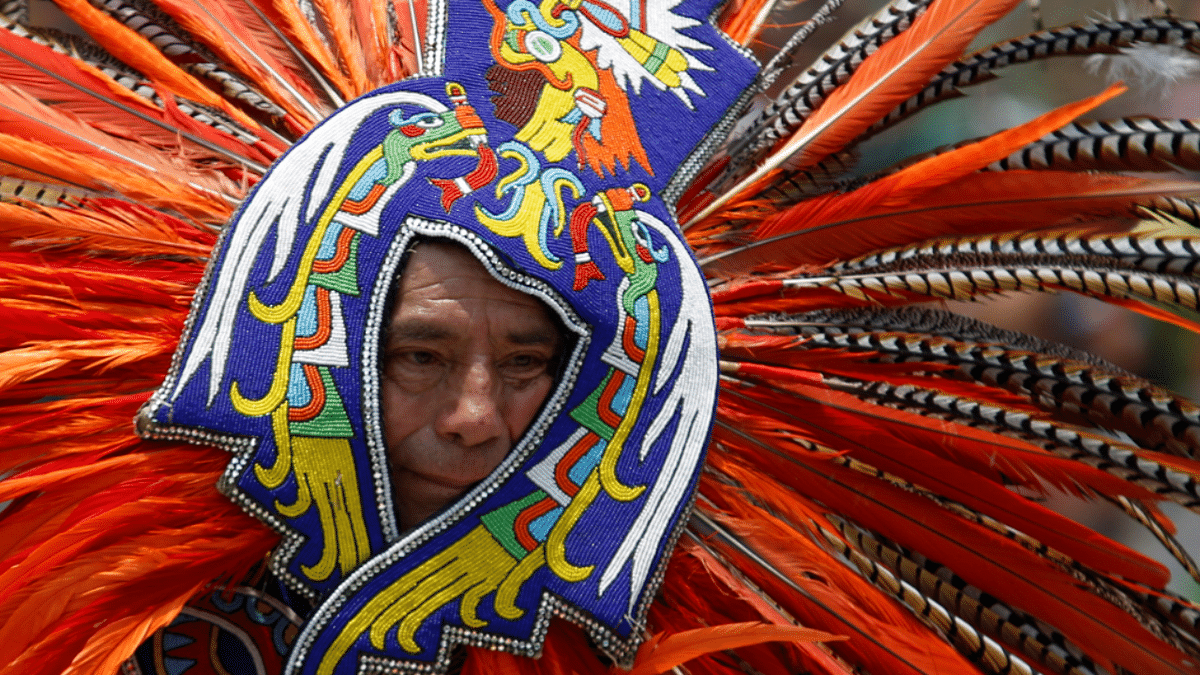 A man wearing a traditional costume dances to mark the 500th anniversary of the Fall of Tenochtitlan, at Zocalo square in downtown Mexico City, Mexico. Credit: Reuters Photo