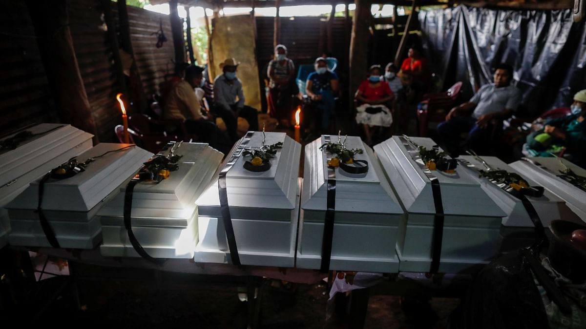 Members of the Luna family take part in wake of the remains of five children and three adults who were killed in a military operation in March 1980 during El Salvador Civil war, in Cacaopera, El Salvador. Credit: Reuters Photo