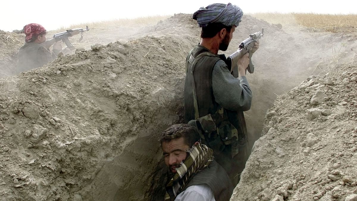 Northern Alliance soldiers fire at a front line position near Charatoy in the north of Afghanistan. Credit: Reuters Photo