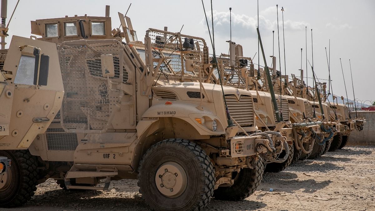 US Army soldiers from the 10th Mountain Division and US contractors prepare Mine Resistant Ambush Protected vehicles, MRAPs, to be transported off of base in support of the withdrawal mission in Kandahar, Afghanistan. Credit: Reuters Photo