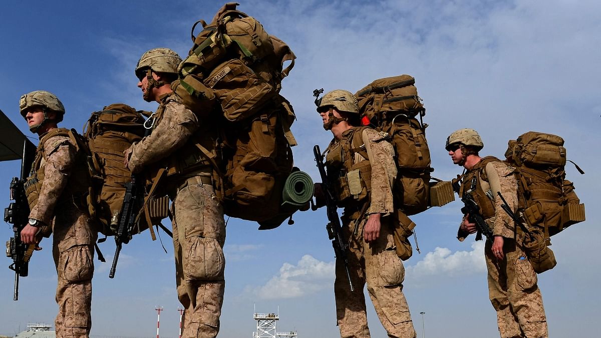 US Marines board a C-130J Super Hercules transport aircraft headed to Kandahar as British and US forces withdraw from the Camp Bastion-Leatherneck complex at Lashkar Gah in Helmand province on October 27, 2014. Credit: AFP Photo