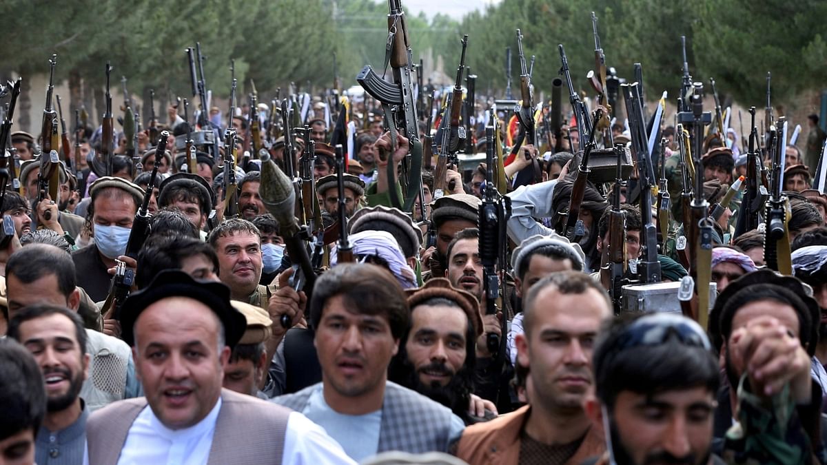 Hundreds of armed men attend a gathering to announce their support for Afghan security forces and that they are ready to fight against the Taliban, on the outskirts of Kabul, Afghanistan. Credit: Reuters Photo
