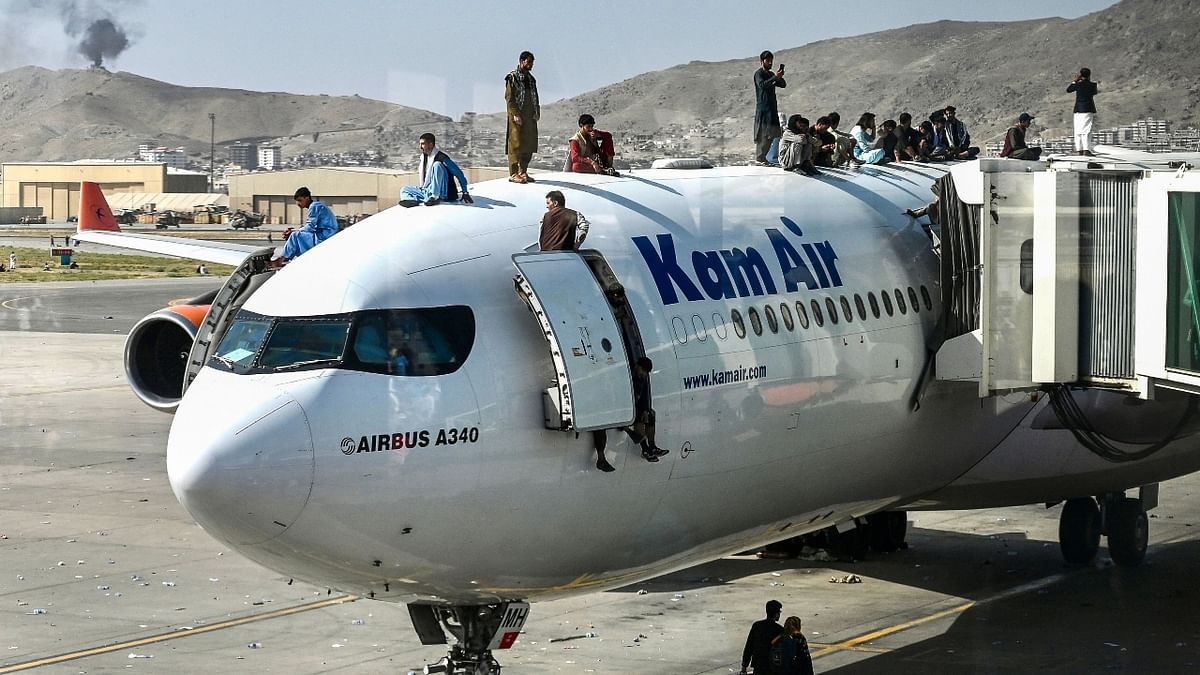 Afghans rushed onto the tarmac of the Kabul airport as thousands tried to flee the country after the Taliban seized power with stunning speed on August 16, 2021. Credit: AFP Photo